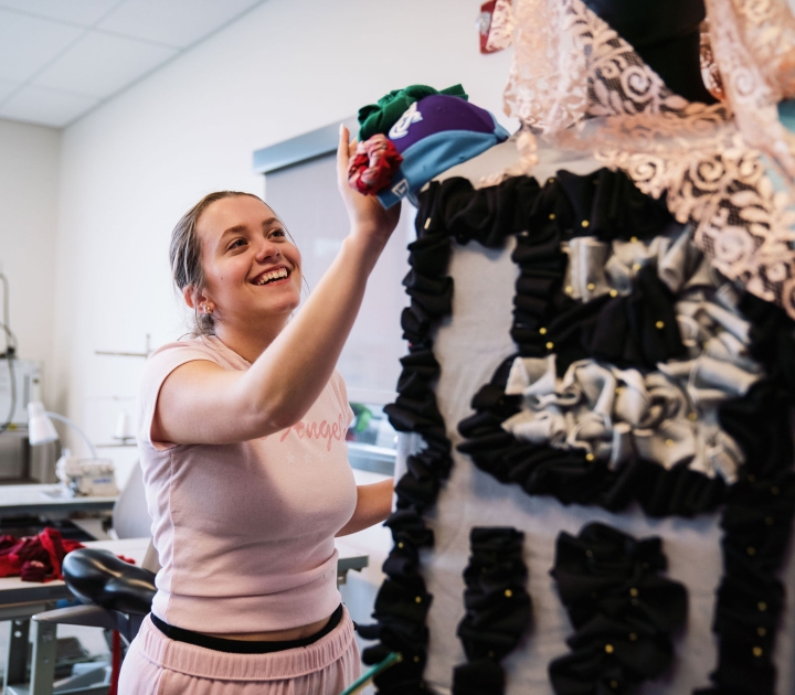 A female student works on a mannequin design