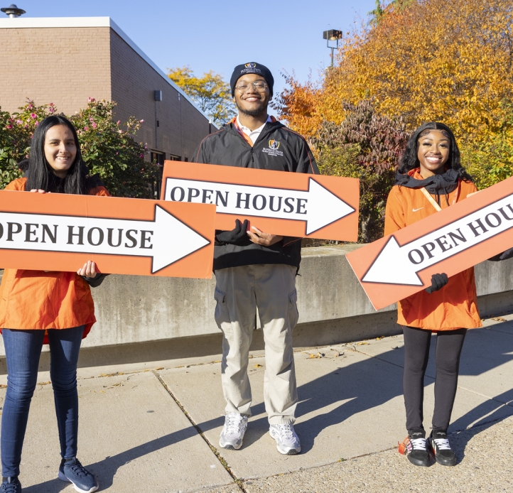 Students holding Open House signs